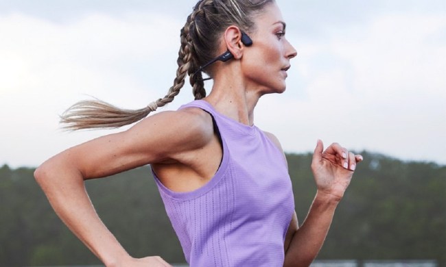 A runner wearing the Shokz OpenRun Pro bone conduction headphones.