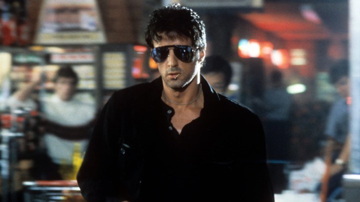 Sylvester Stallone walks forward in a scene from Cobra.