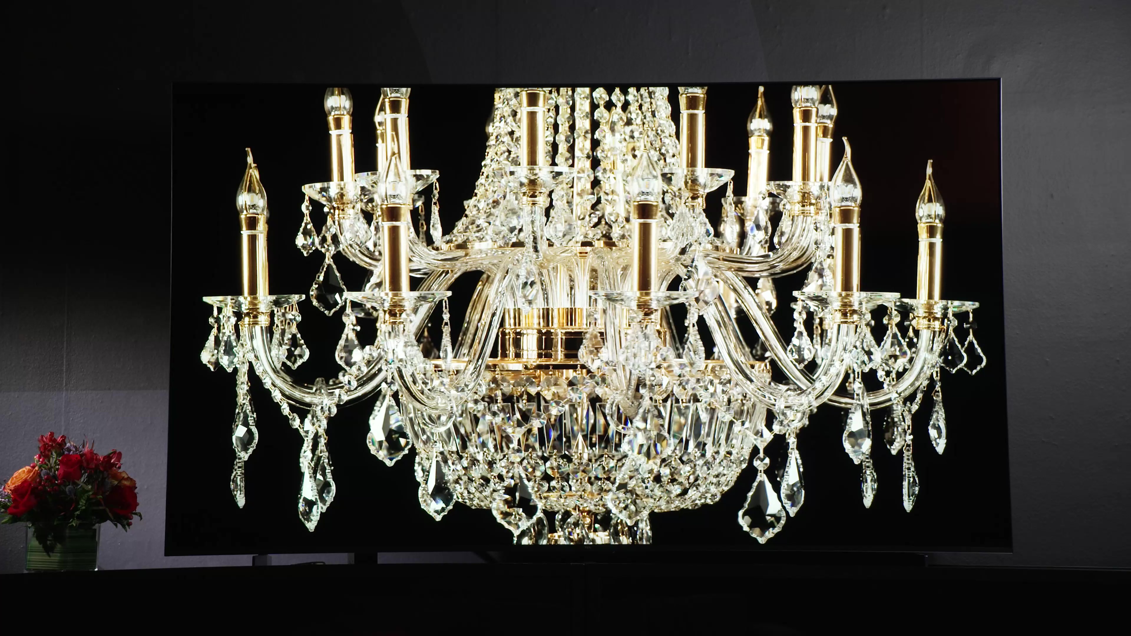 A crystal chandelier displayed on a TCL QM8 Mini-LED TV.
