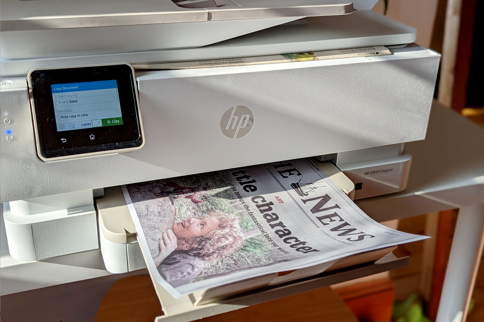 The HP Envy Inspire 7955e makes a copy of a newspaper's art section.