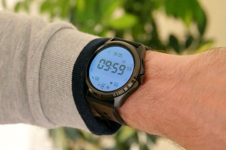 The Mobvoi TicWatch Pro 5 on a person's wrist, showing the backlit secondary screen.
