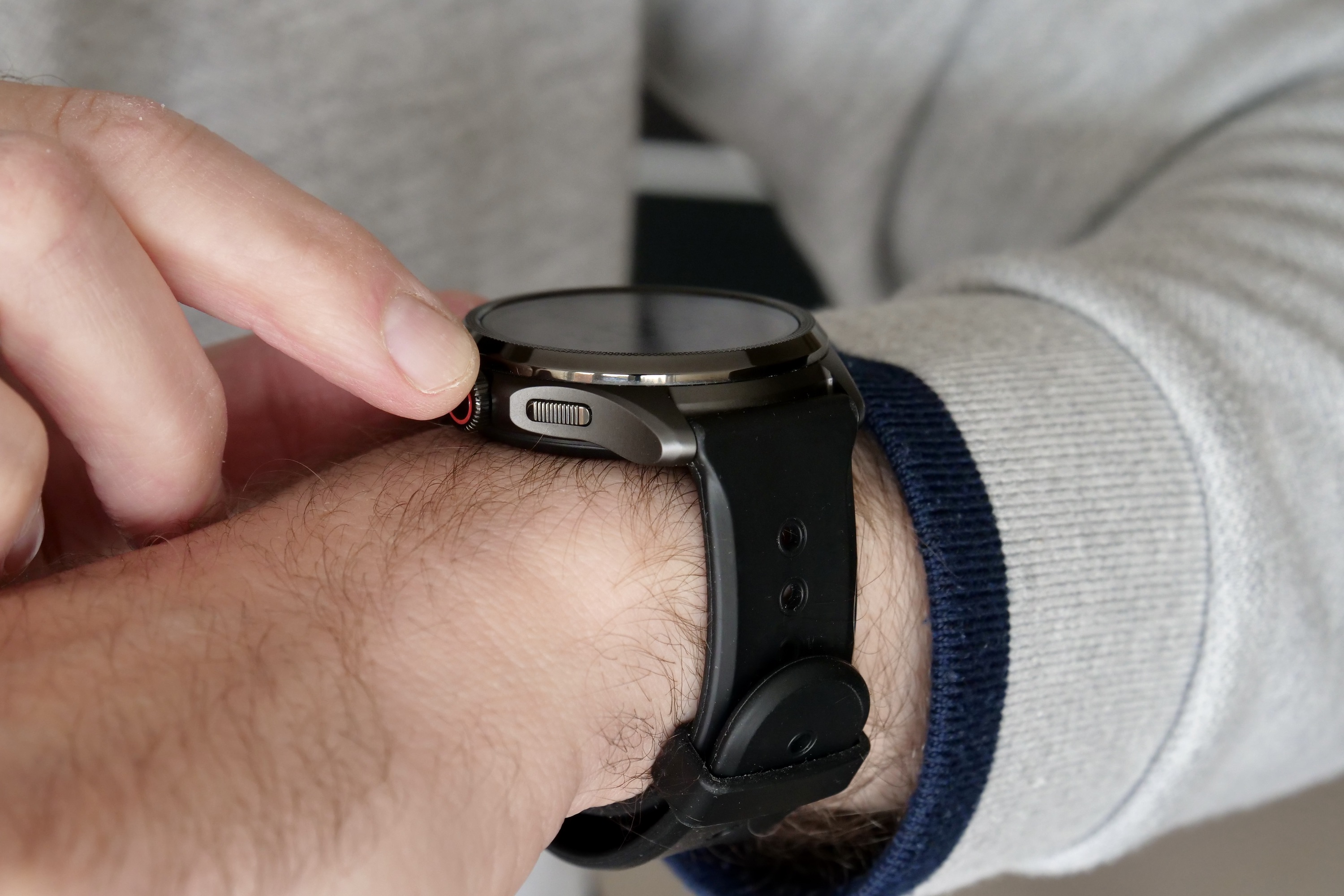 The Mobvoi TicWatch Pro 5 on a person's wrist, showing the side button.