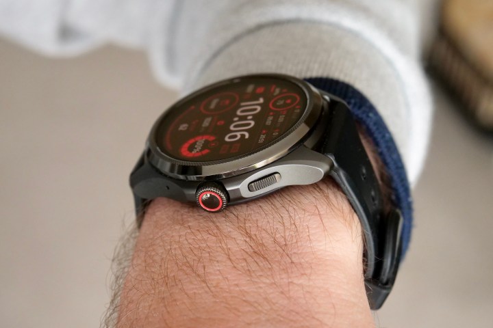 The Mobvoi TicWatch Pro 5 on a person's wrist, showing the crown and side button.