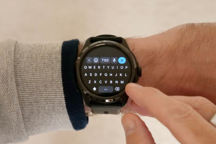 The Mobvoi TicWatch Pro 5 on a person's wrist, showing the keyboard.