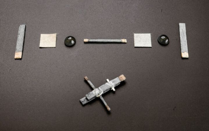 The components of a wooden transistor laid out on a table.