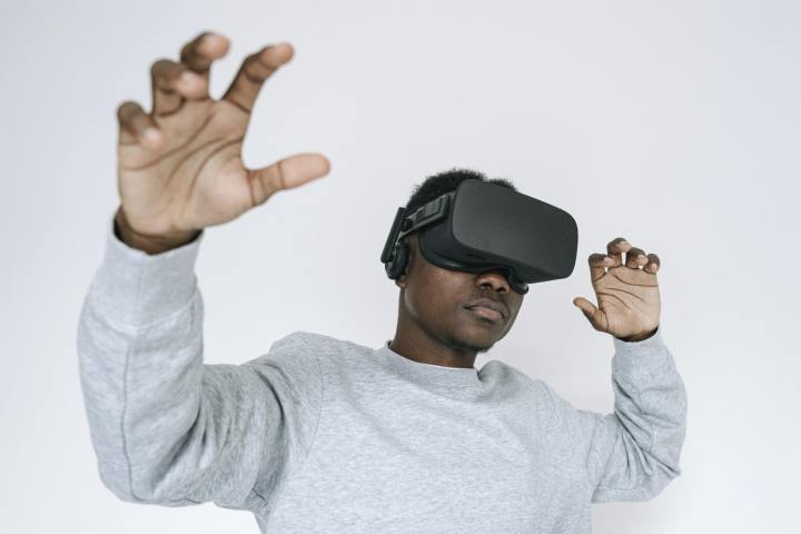 A person using a virtual reality headset against a white background.