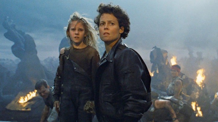 Ripley and Newt stand in a deserted field in Aliens.