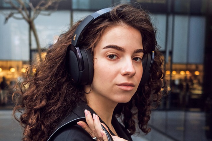 A woman wearing the Edifier WH950NB ANC headphones.