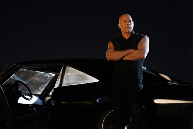 Vin Diesel leans against a car in Fast X.