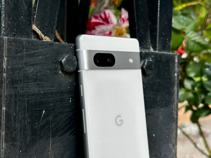 Google Pixel 7a in Snow leaning on garden post