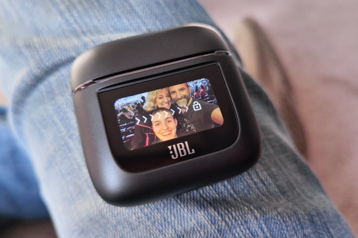 JBL Tour Pro 2 in case, with customized lock screen displayed.