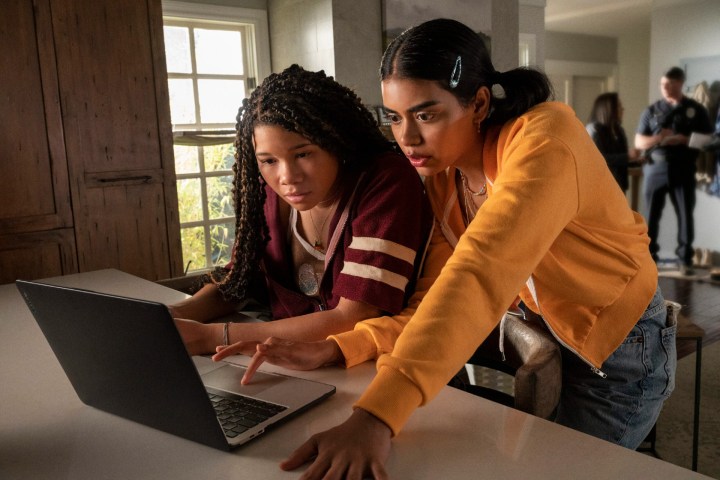 Two girls look at a computer in Missing.