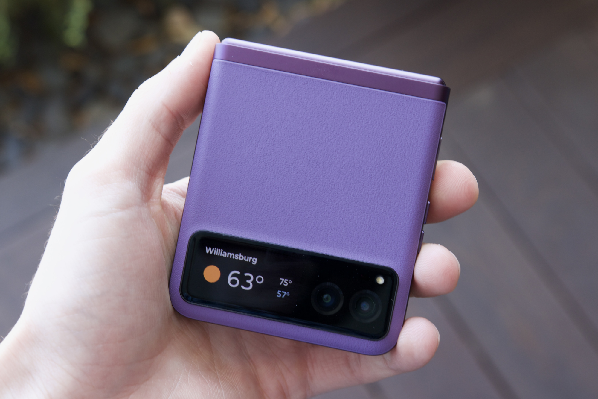 Someone holding the purple Motorola Razr (2023).
