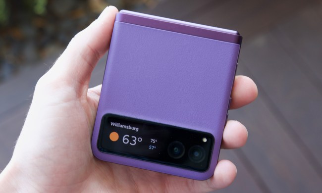Someone holding the purple Motorola Razr (2023).