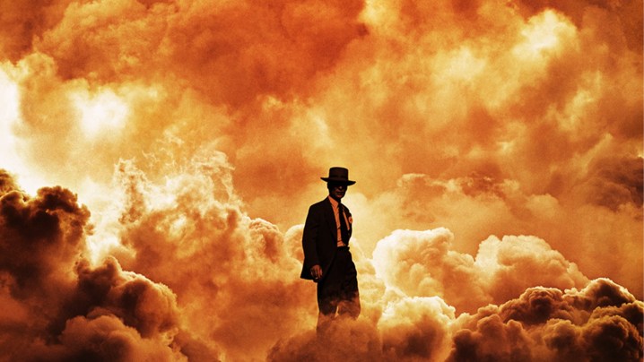 A man walks through fire and smoke in Oppenheimer.