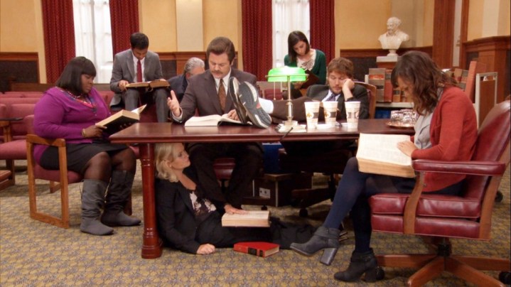 Leslie and the gang study in Parks and Recreation.