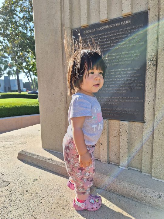 Toddler standing on park monument taken with a Samsung Galaxy A54