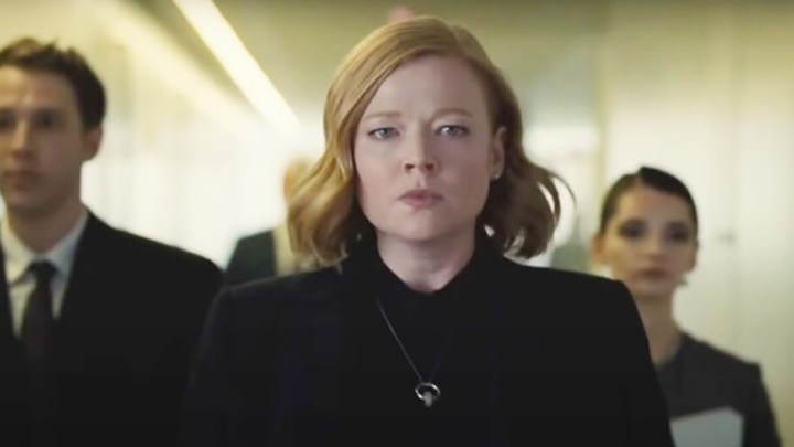 Shiv angry walking down a hallway with people behind her in a scene from Succession.