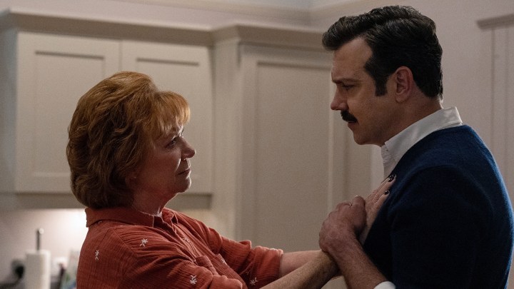 Ted's mom Dottie with her hands on his chest, him holding them in a scene from Ted Lasso.