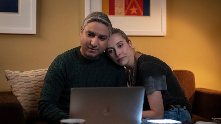 Jade's head on Nate's shoulder as the look at a computer in a scene from Ted Lasso.