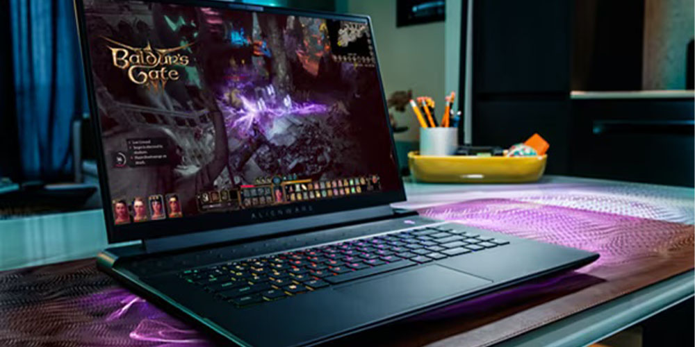 An Alienware m16 gaming laptop in use on a desk, playing Baldur's Gate III.