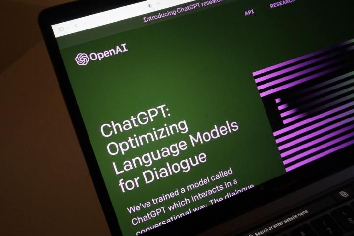 The laptop screen displays the homepage of ChatGPT, OpenAI's artificial intelligence chatbot.