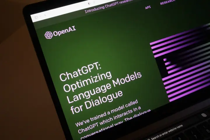 A laptop screen shows the home page for ChatGPT, OpenAI's artificial intelligence chatbot.