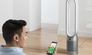 The Dyson Purifier Cool TP07 smart air purifier and fan in a room with a man.