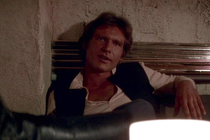 Han Solo reclines in a cantina booth in Star Wars: A New Hope.
