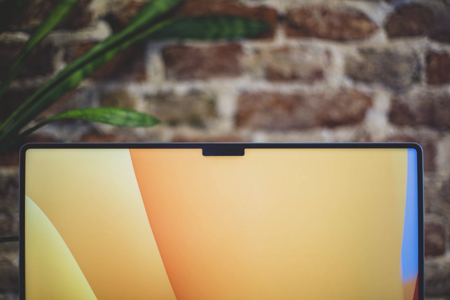 An Apple MacBook laptop with the macOS Ventura background wallpaper and the notch seen at the top of the display.