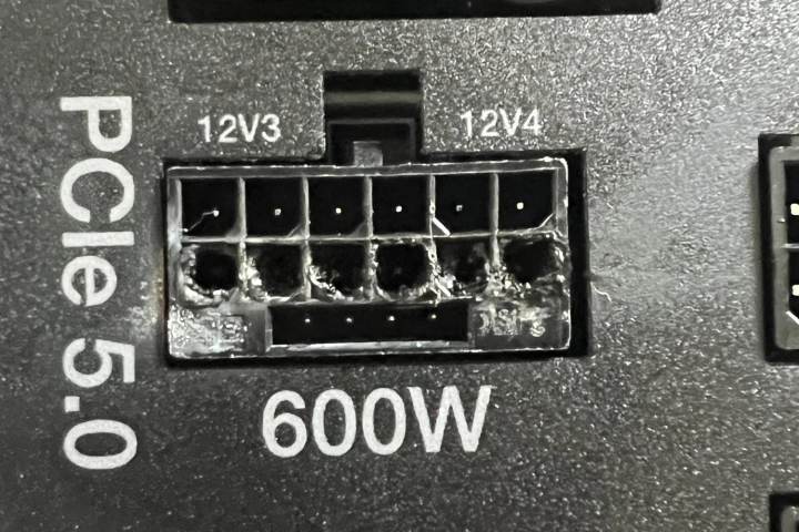 बिजली आपूर्ति पर ग्राफिक्स कार्ड कनेक्टर। कनेक्टर्स को जलाया और पिघलाया जाता है, जहां से एक RTX 4090 ग्राफिक्स कार्ड से एनवीडिया 12VHPWR केबल को प्लग इन किया जाता है और ज़्यादा गरम किया जाता है।