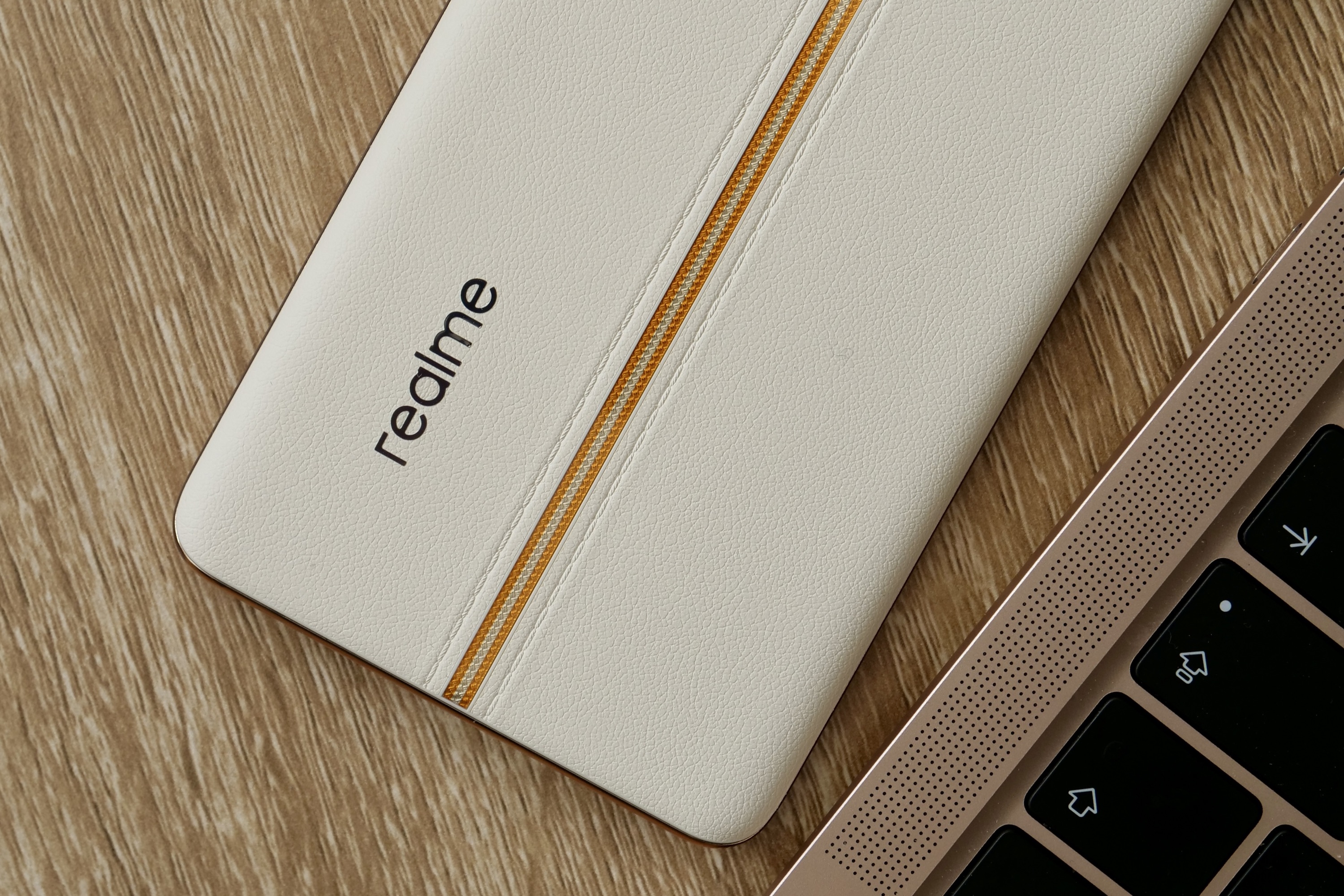 The Realme logo and fake leather rear panel on the Realme 11 Pro+.