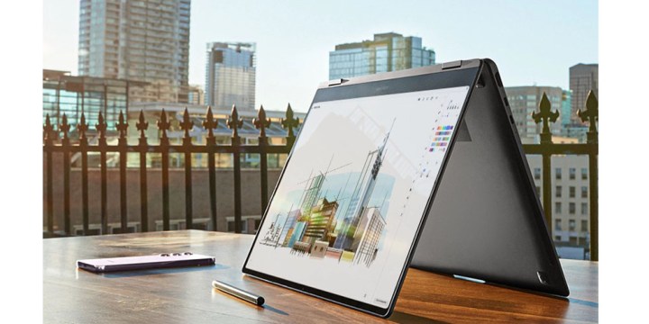 The Samsung Galaxy Book 3 360 in tent mode on a balcony with attractive scenery nearby.
