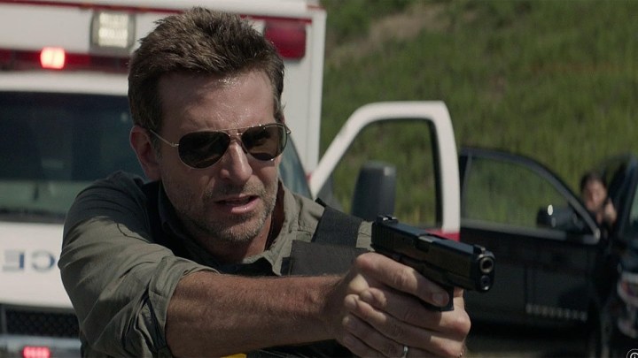 Bradley Cooper aims his gun in The Mule.