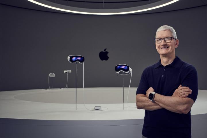 Apple CEO Tim Cook standing in front of four Vision Pro headsets.