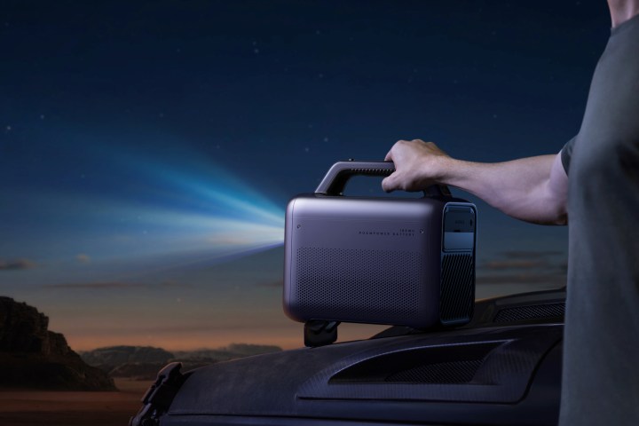 The Anker Nebula Mars 3 outdoor projector shooting a beam of light.