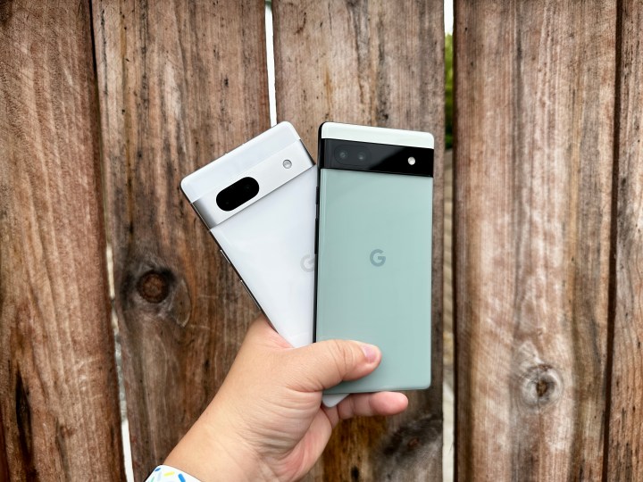 Sage green Pixel 6a and Snow Pixel 7a held in hand