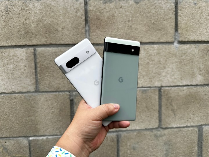 Sage green Pixel 6a and Snow Pixel 7a in hand