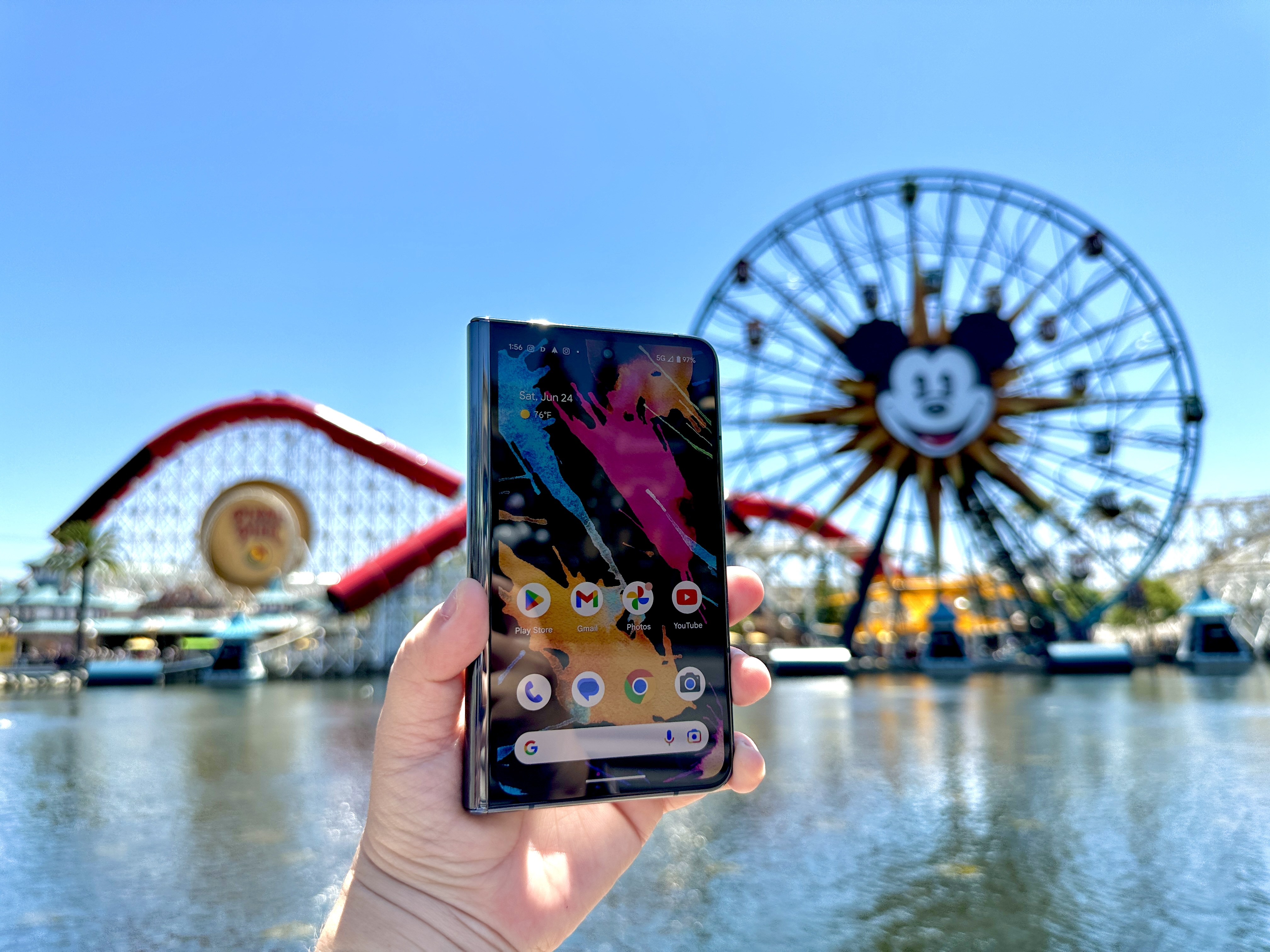 Google Pixel Fold in Obsidian held in hand showing home screen at Pixar Pier.