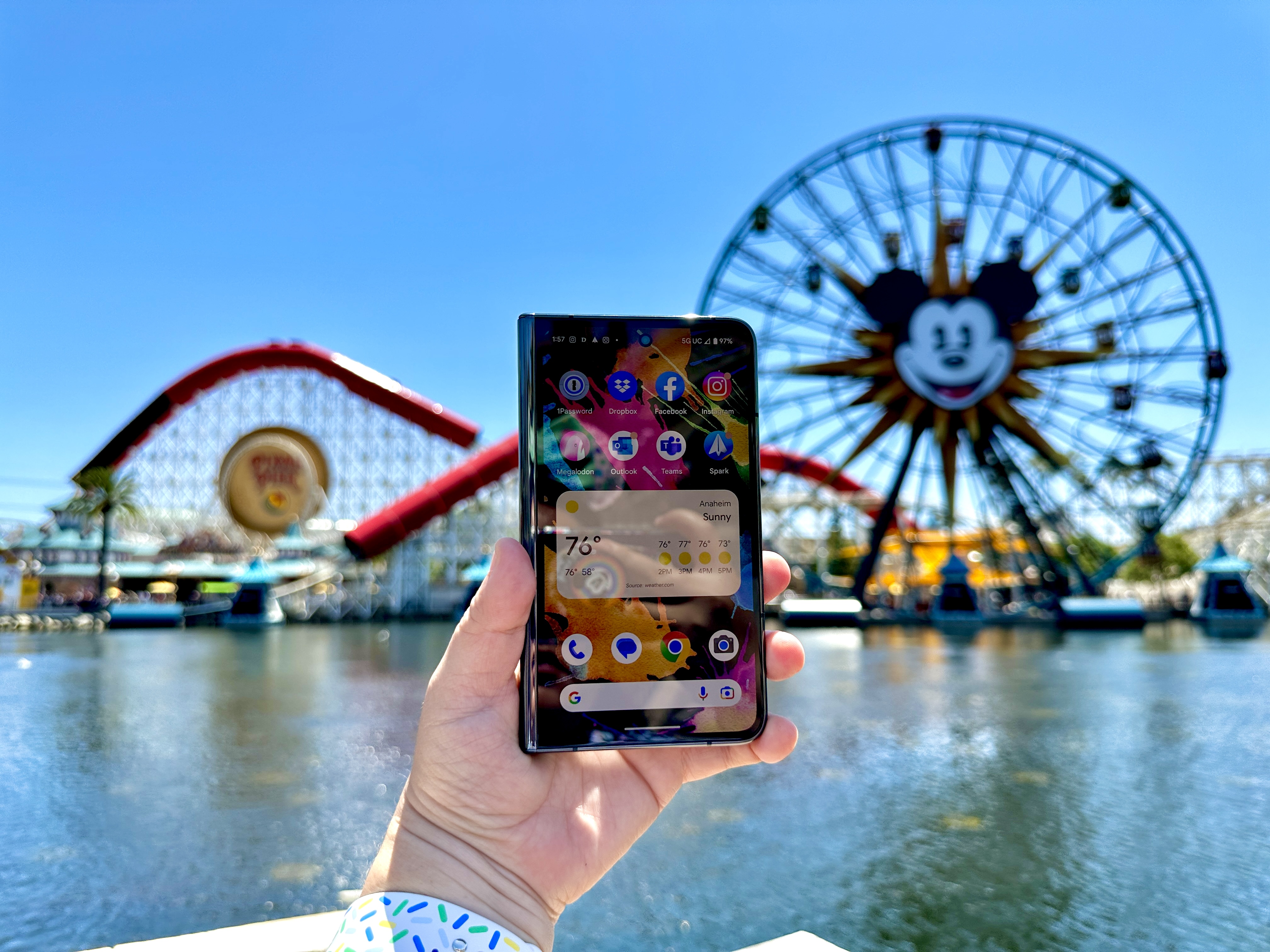Google Pixel Fold in Obsidian open in hand showing a home screen at Pixar Pier.