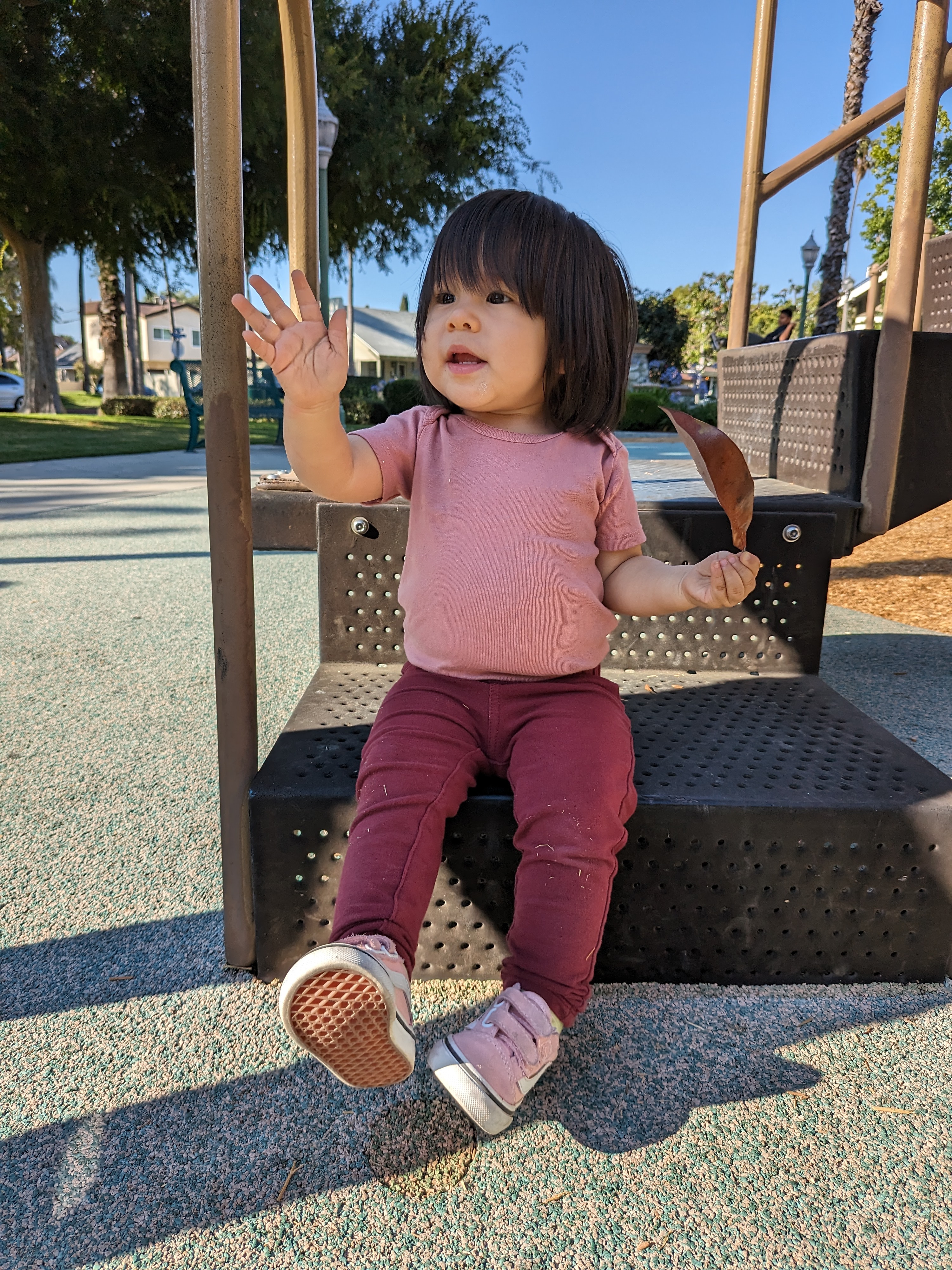 Toddler daughter sitting and waving taken with Google Pixel Fold.