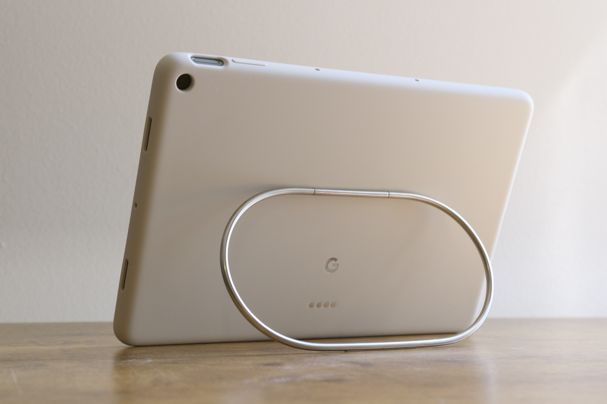 The Google Pixel Tablet being propped up on a desk with its official case.