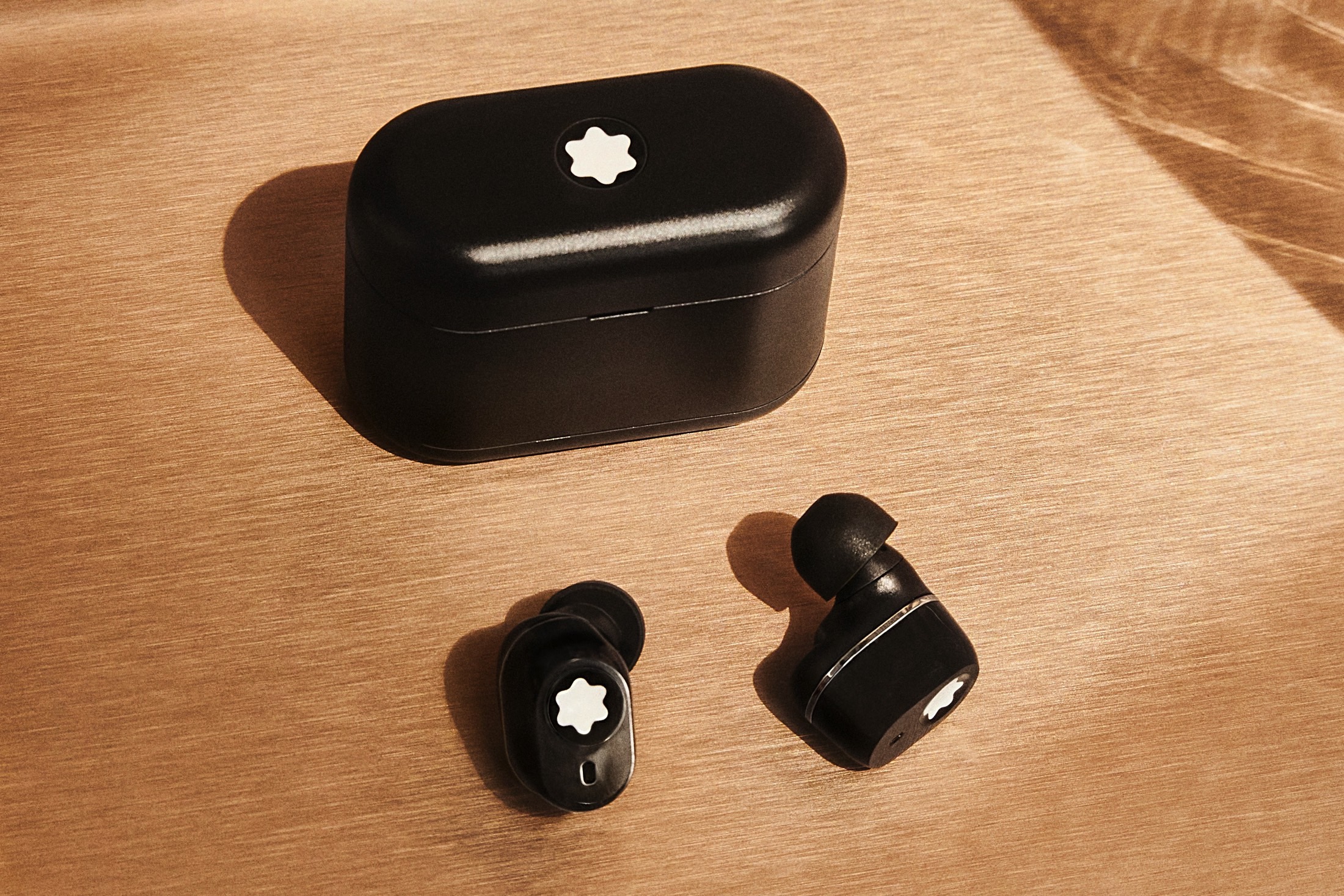 Montblanc MTB 03 wireless earbuds with charging case.