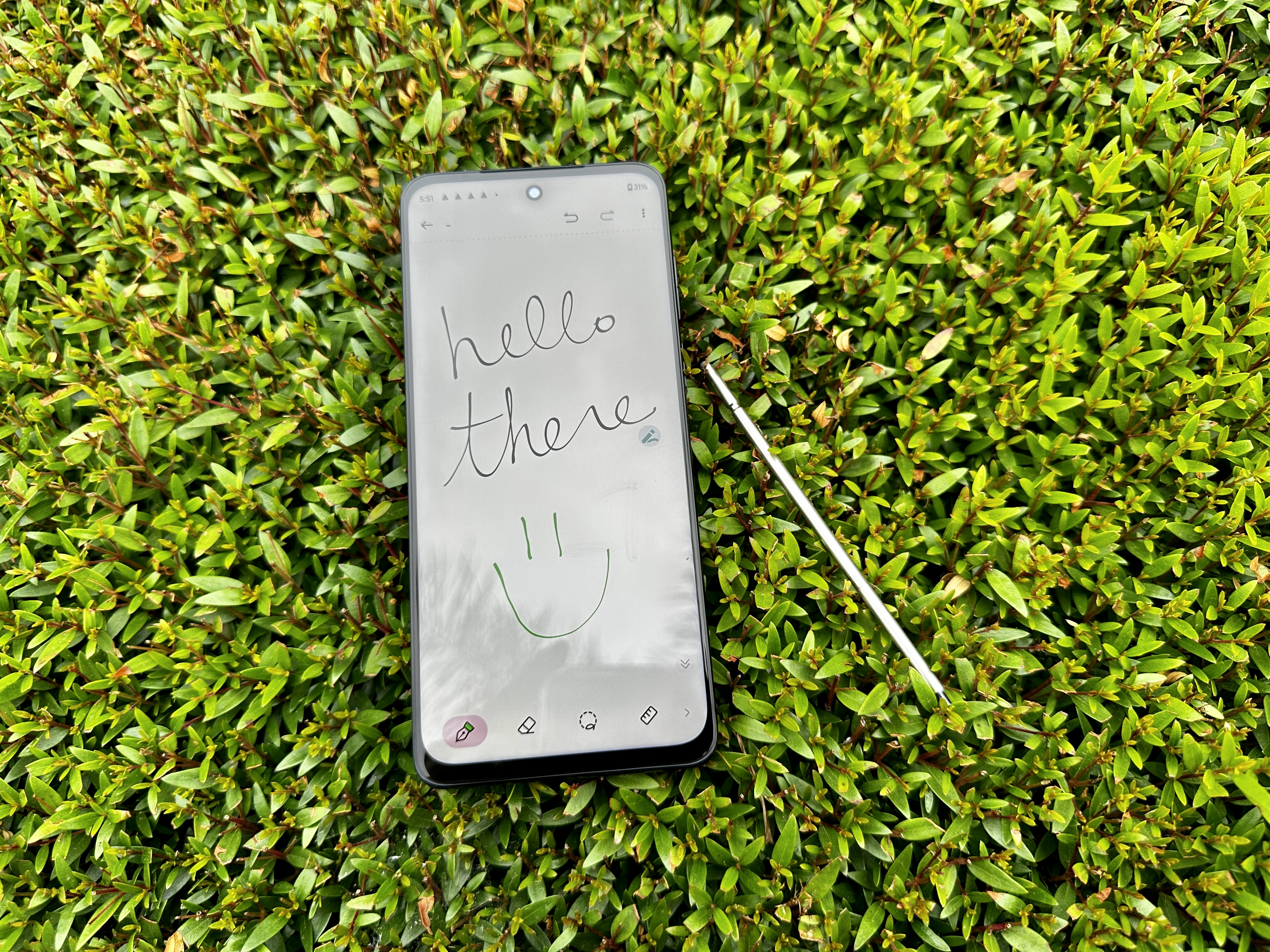 Moto G Stylus 5G 2023 in bush with handwritten note that reads "Hello There."