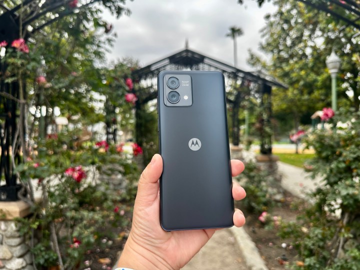Moto G Stylus 5G 2023 in hand with a rose garden backdrop. 