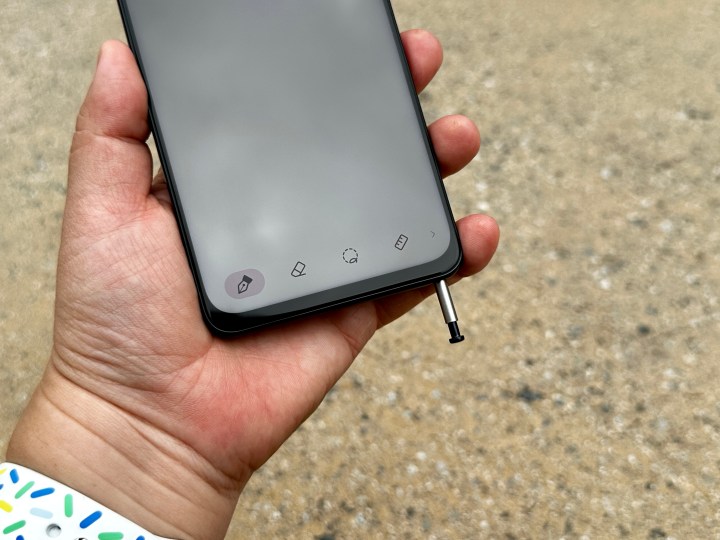 Moto G Stylus 5G 2023 in hand with stylus popped out.