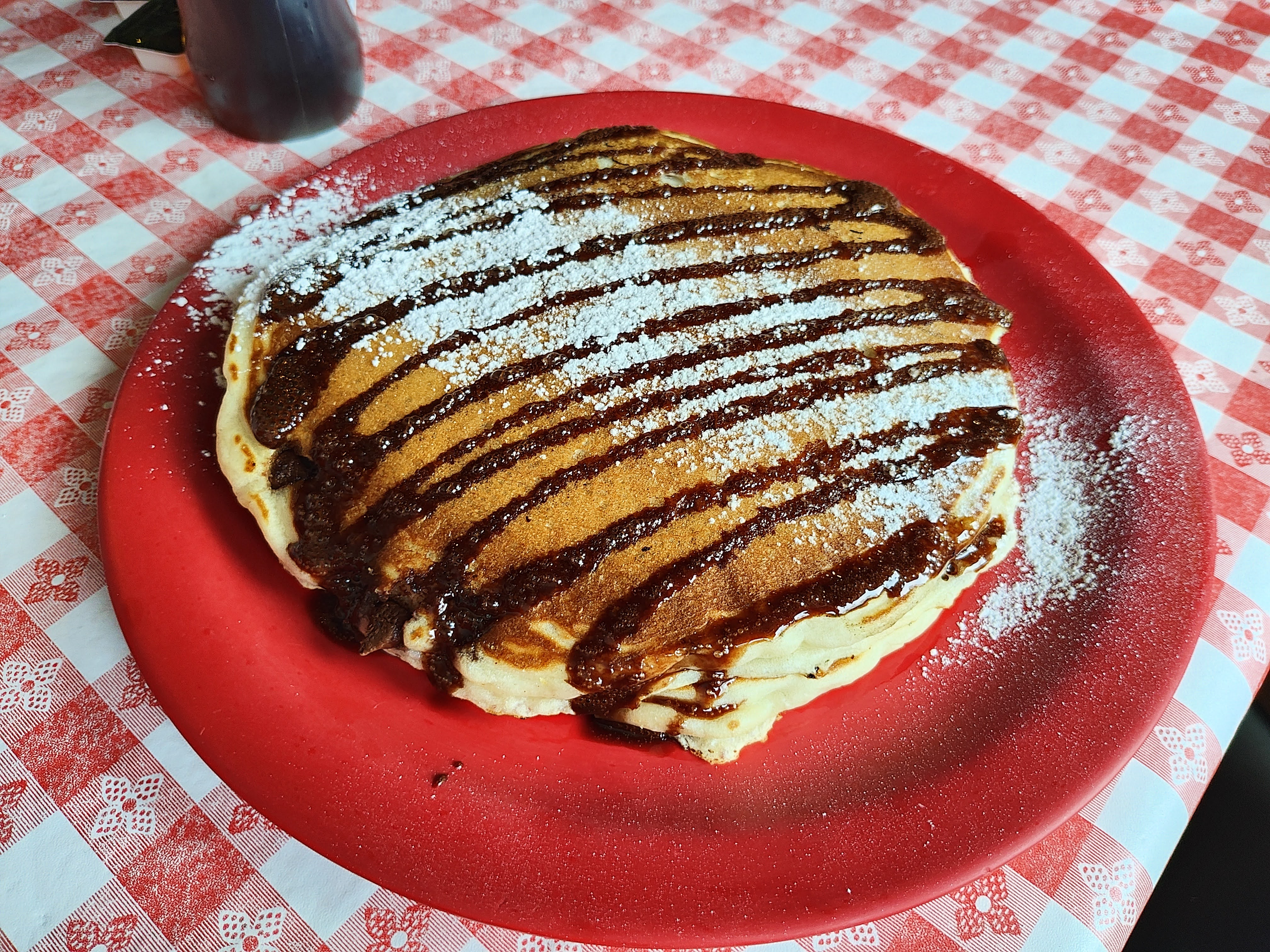 Chocolate chip pancakes on a red plate, taken with the Motorola Razr Plus.