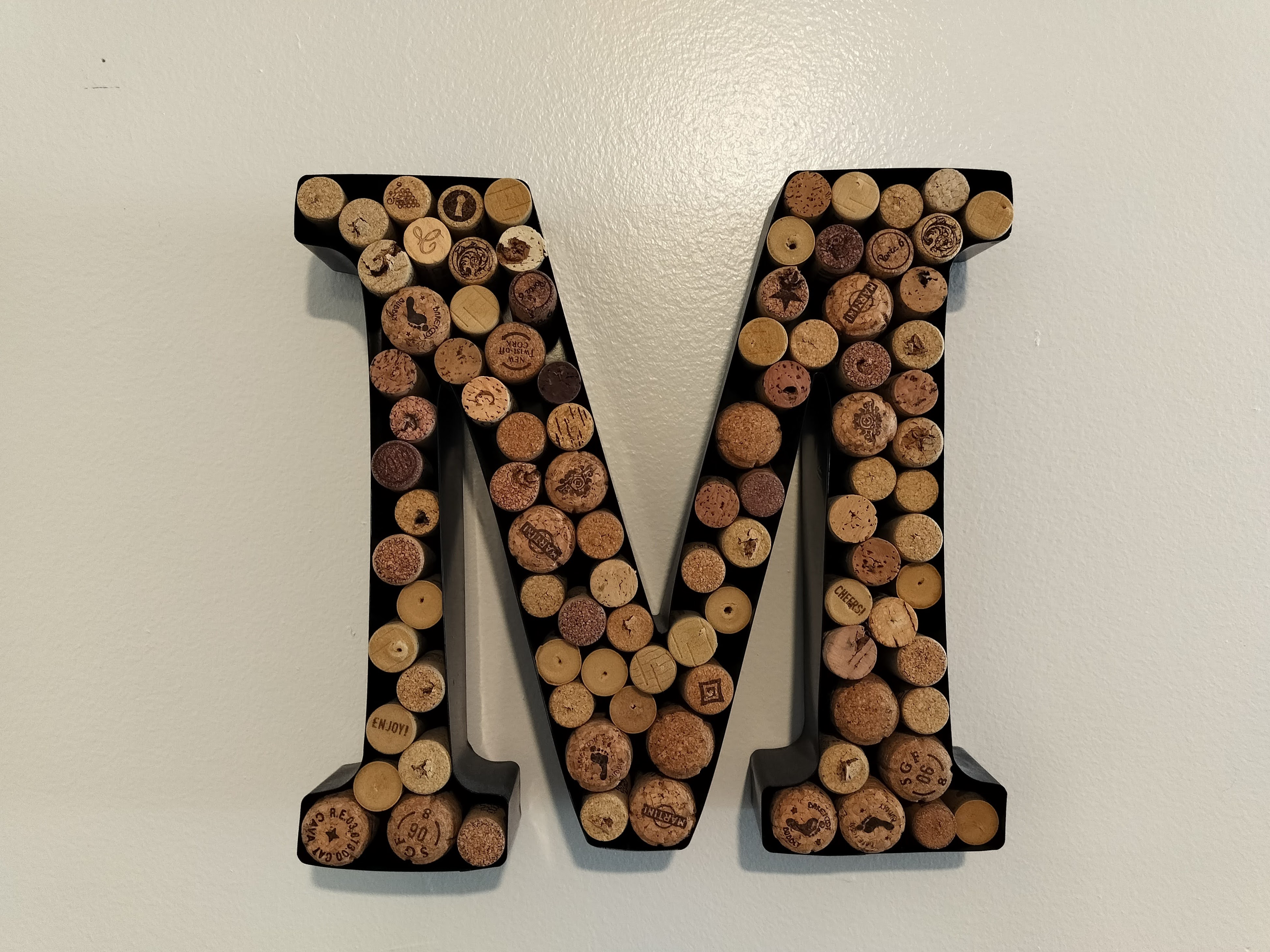 Photo of an "M" decoration filled with wine corks taken with the OnePlus Nord N30 5G.