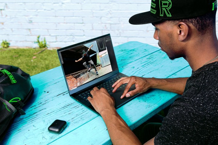 Someone using the Razer Blade 14 on a table.