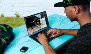 Someone using the Razer Blade 14 on a table.